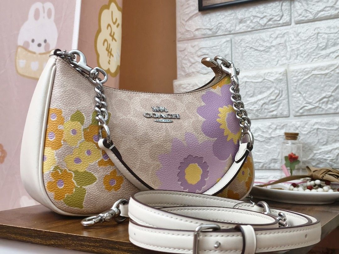 Coach Teri (Category: Luxury Bags & Wallets) located in Ormoc. Submitted by jonaprelove (Listing ID 1439840887, Image 1). Description: - Coach shoulder bag - Beautiful floral print design - Includes chain strap and adjustable strap - Beige base with colorful floral accents - White side panels - Coach logo on front - Stylish and versatile.
