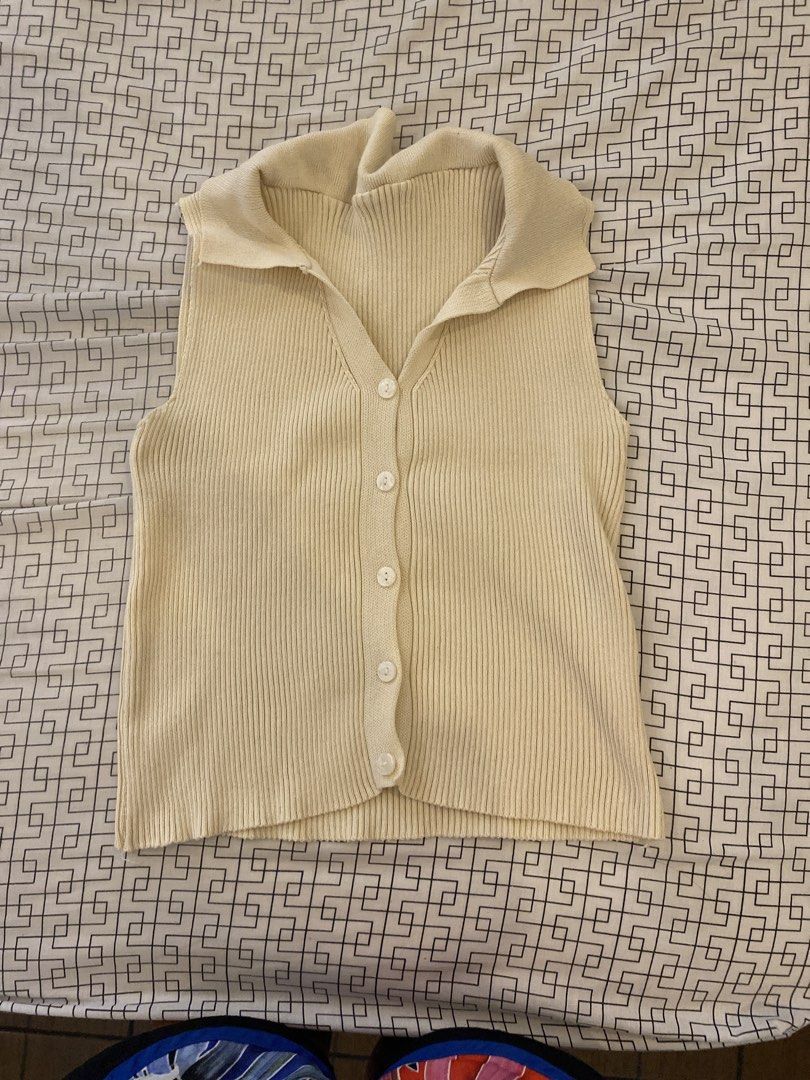 Cream Sleeveless Collared Top Blouse | preloved clothes (Category: Sleeveless) located in Las Pinas. Submitted by declutterwithakii (Listing ID 1439824412, Image 1). Description: - Cream-colored sleeveless top - Collared neckline - Button-down front - Ribbed texture - Lightweight knit material - Neutral color for easy pairing.
