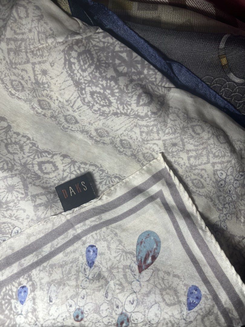 DAKS Silk Scarf with Lace and Key Design (Category: Scarves) located in Cebu City. Submitted by 7paws (Listing ID 1439984402, Image 1). Description: - Brand: DAKS - Design: Delicate lace pattern with key and bow motifs - Colors: Grey, white, and subtle blue accents - Style: Classic, elegant - Perfect for: Adding a sophisticated touch to any outfit.