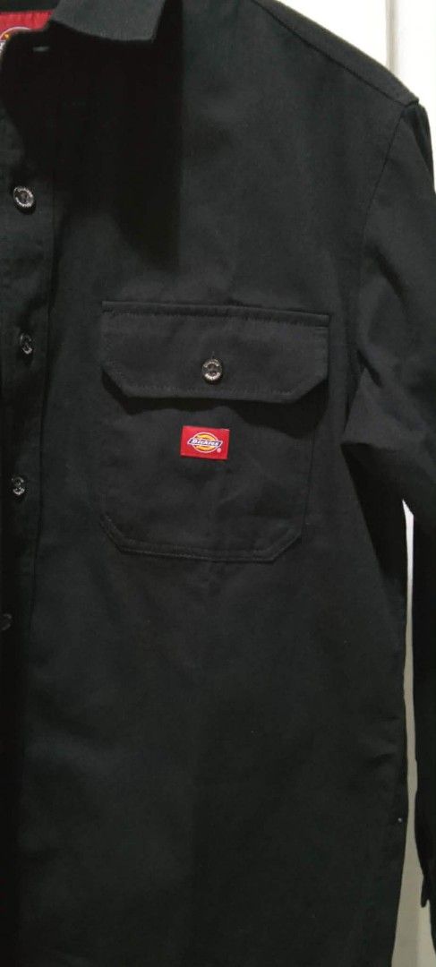 Dickies Black Long Sleeve Shirt (Category: Tshirts & Polo Shirts ) located in Bago City. Submitted by champsthrift (Listing ID 1439884795, Image 2). Description: - Dickies long sleeve shirt - Size: M - Features: Two chest pockets, button-down closure - Design: Red Dickies logo patch on chest pocket - Material: Polyester and cotton blend.