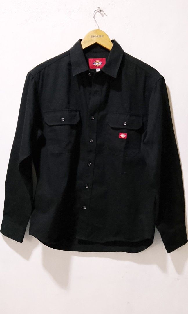 Dickies Black Long Sleeve Shirt (Category: Tshirts & Polo Shirts ) located in Bago City. Submitted by champsthrift (Listing ID 1439884795, Image 1). Description: - Dickies long sleeve shirt - Size: M - Features: Two chest pockets, button-down closure - Design: Red Dickies logo patch on chest pocket - Material: Polyester and cotton blend.
