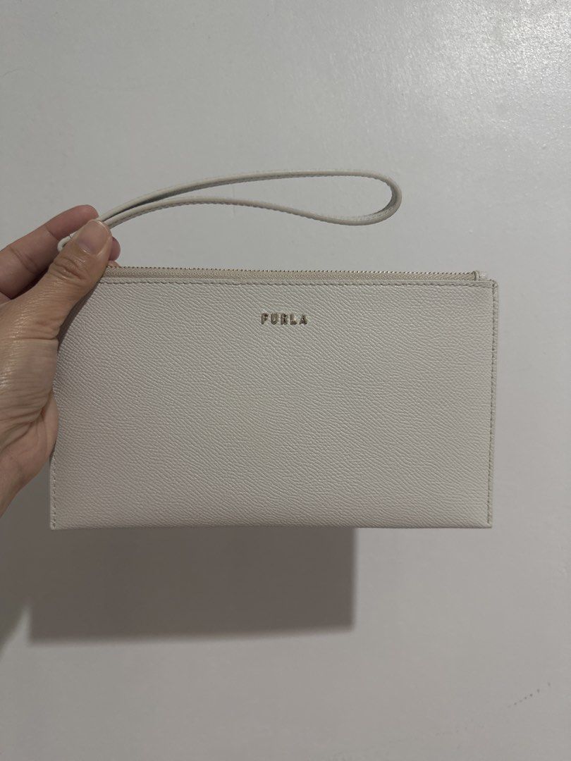 Furla Genuine Leather Wristlet (Category: Luxury Bags & Wallets) located in Cainta. Submitted by xyzasisa (Listing ID 1439931950, Image 1). Description: - Genuine leather Furla clutch - Secure zipper closure - Convenient wrist strap - Versatile neutral color.