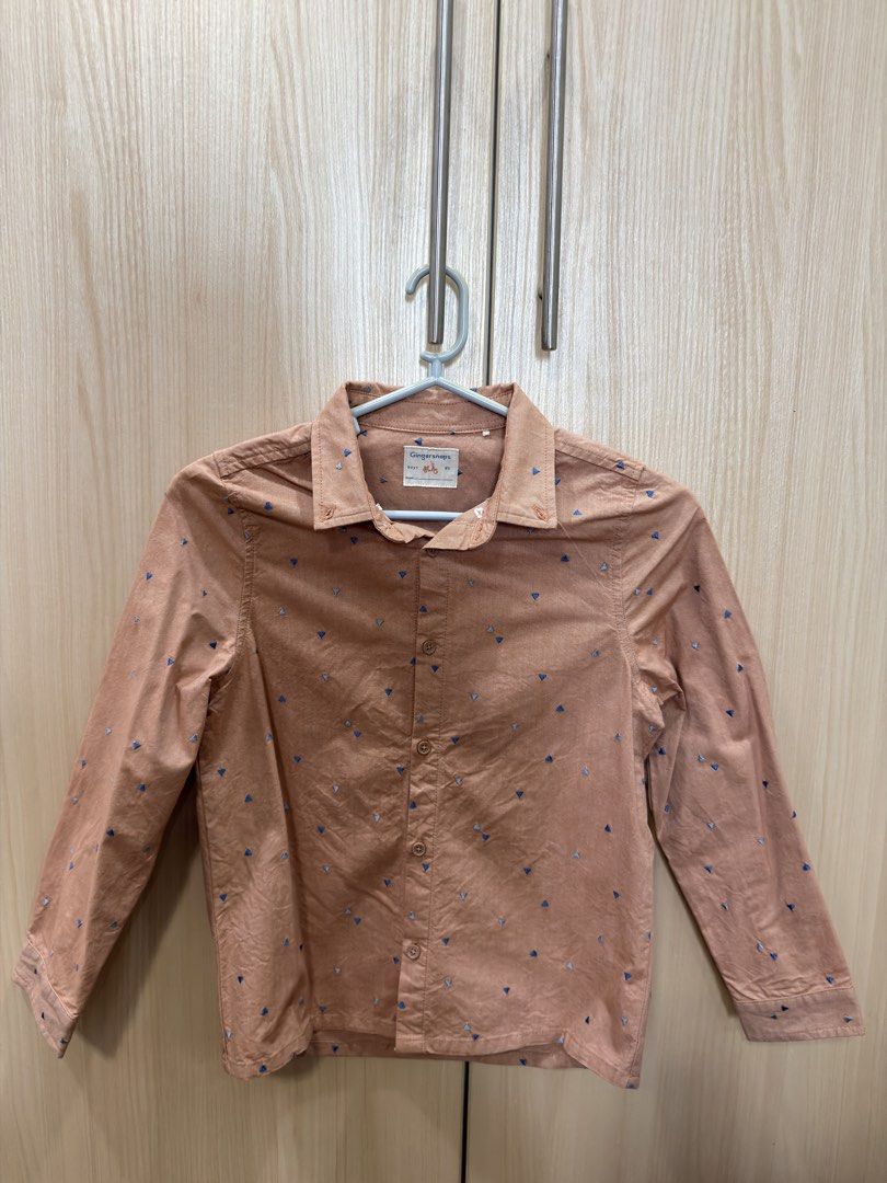 Gingersnaps Boys Shirt 8Y (Category: Babies & Kids Fashion) located in San Juan City. Submitted by addieandmatty (Listing ID 1439850048, Image 1). Description: - Gingersnaps boys' shirt - Size: 8Y - Design: Button-down, long sleeves - Color: Light brown - Pattern: Small blue and white triangles - Neckline: Collared - Fit: Classic.