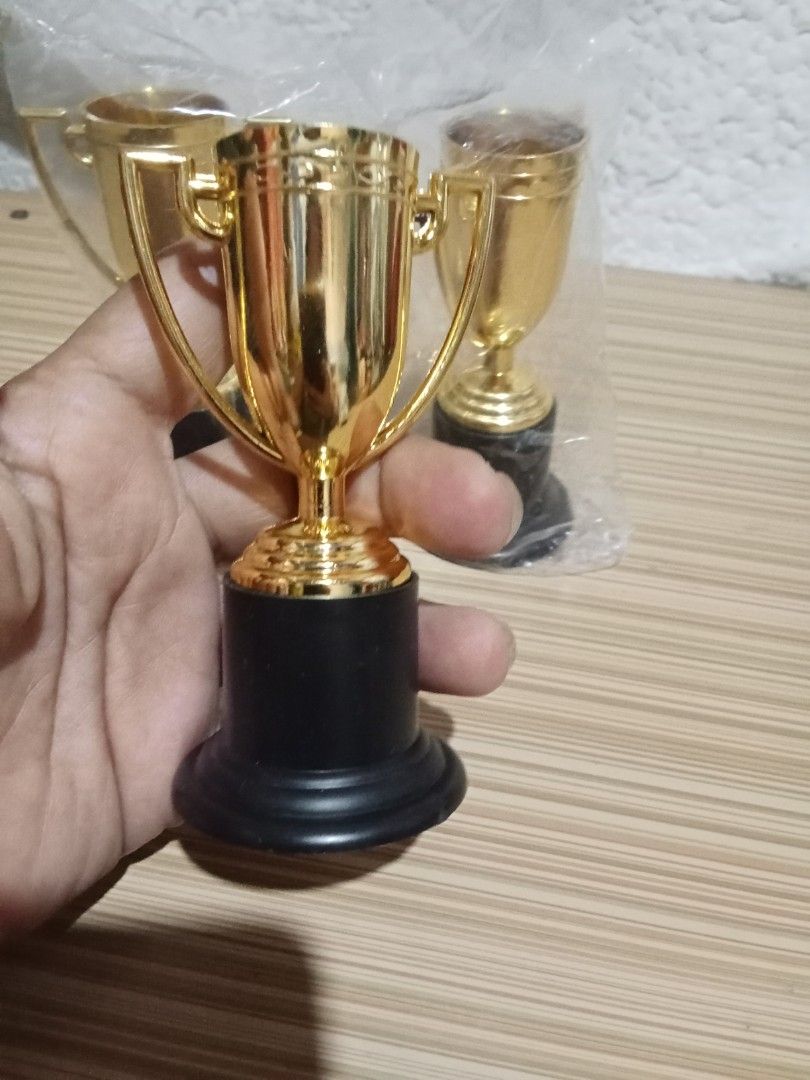 Gold Mini Trophies with Black Base (Category: Vintage Collectibles) located in Bocaue. Submitted by marajapansurplus (Listing ID 1439926824, Image 2). Description: - Set of three mini gold trophies - Classic cup design with handles - Sturdy black bases - Perfect for awards, party favors, or decorations - Celebrate any achievement.