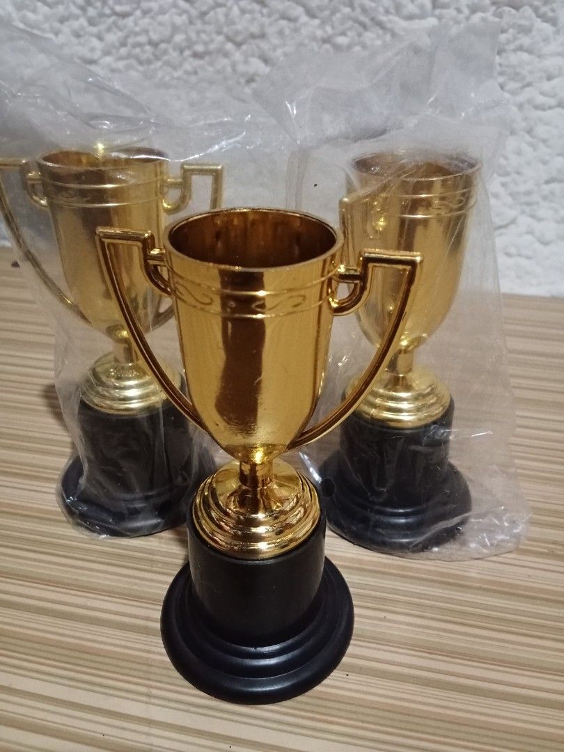 Gold Mini Trophies with Black Base (Category: Vintage Collectibles) located in Bocaue. Submitted by marajapansurplus (Listing ID 1439926824, Image 1). Description: - Set of three mini gold trophies - Classic cup design with handles - Sturdy black bases - Perfect for awards, party favors, or decorations - Celebrate any achievement.