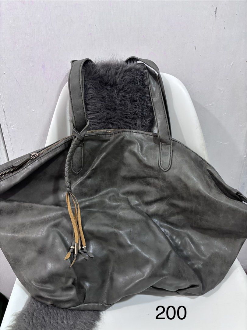 Grey Leather Tote Bag (Category: Tote Bags) located in Quezon City. Submitted by makeitkmn (Listing ID 1439887516, Image 1). Description: - Grey leather tote bag - Zipper closure - Braided detail and tassel - Spacious interior - Two handles.