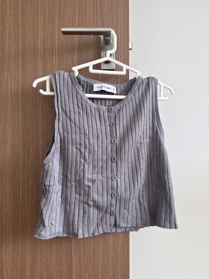 Grey Ribbed Button-Up Tank Top (Category: Sleeveless) located in Singapore. Submitted by _gentlenight (Listing ID 1439846140, Image 1). Description: - Grey ribbed tank top - Button-up design - Comfortable knit material - Versatile for various outfits - Suitable for layering or standalone wear.