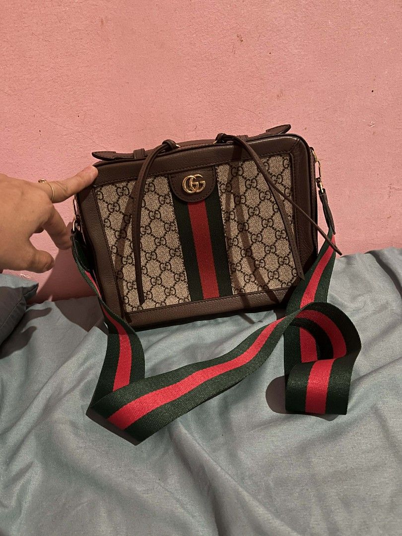 Gucci GG Supreme Shoulder Bag (Category: Luxury Bags & Wallets) located in Urdaneta. Submitted by ilovemomohiraii (Listing ID 1439828912, Image 1). Description: - Authentic Gucci shoulder bag - Iconic GG Supreme canvas with red and green stripe - Brown leather trim - Detachable shoulder strap - Interior zippered pocket - Gucci logo and "Made in Italy" tag.