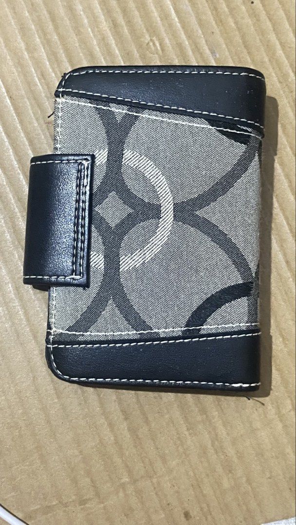 Guess Monogrammed Bifold Wallet with Coin Pouch (Category: Wallets & Card holders) located in Marilao. Submitted by coolpenguin.1935ba (Listing ID 1439896079, Image 2). Description: - Stylish Guess wallet with classic monogram pattern - Black leather trim for a sophisticated look - Bifold design for easy organization - Multiple card slots to hold all your cards - Clear ID window for quick access - Secure coin pouch with a snap closure BRAND: ByGe