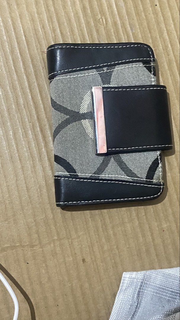 Guess Monogrammed Bifold Wallet with Coin Pouch (Category: Wallets & Card holders) located in Marilao. Submitted by coolpenguin.1935ba (Listing ID 1439896079, Image 1). Description: - Stylish Guess wallet with classic monogram pattern - Black leather trim for a sophisticated look - Bifold design for easy organization - Multiple card slots to hold all your cards - Clear ID window for quick access - Secure coin pouch with a snap closure BRAND: ByGe