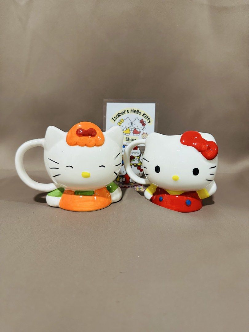 Hello Kitty Ceramic Mugs Set (Category: Coffee & Tea Tableware) located in Angeles City. Submitted by IsaCRSL (Listing ID 1439842760, Image 1). Description: - Adorable set of 2 Kitty ceramic mugs. - Features Kitty in two unique outfits. - Authentic Sanrio product (marked '76, '04). - Perfect for collectors. - Great for coffee, tea, or any beverage..