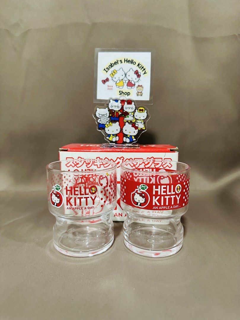 Hello Kitty Pair Glass (Category: Other Kitchenware & Tableware) located in Angeles City. Submitted by IsaCRSL (Listing ID 1439842613, Image 2). Description: - Kitty stacking glasses - Features a red and white design - Adorned with Kitty and apple motifs - Comes with the original box (Japanese text) - Includes a Kitty acrylic stand.