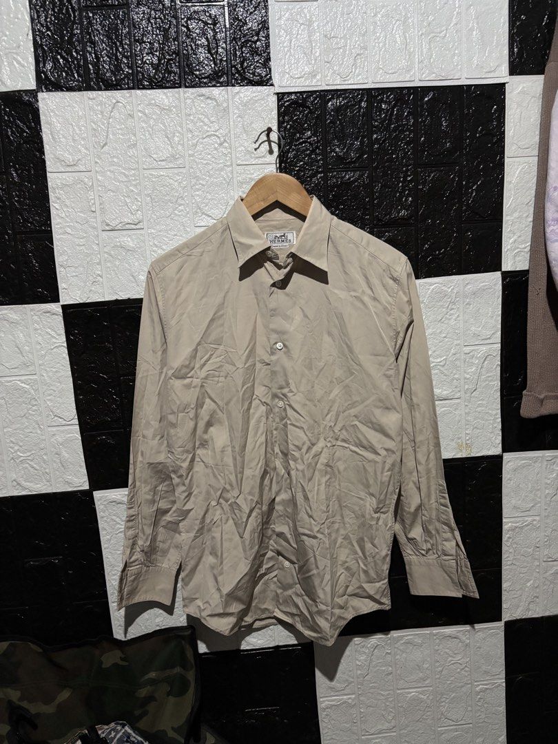 Hermes Beige Long Sleeve Shirt (Category: Luxury Apparel) located in Lopez. Submitted by thrift.ni.roms22 (Listing ID 1439818060, Image 1). Description: - Authentic Hermes long sleeve shirt - Color: Beige - Made in France - Size: 15/38 - Material: 100% cotton - Features a classic collar and button-down closure - A timeless wardrobe staple.
