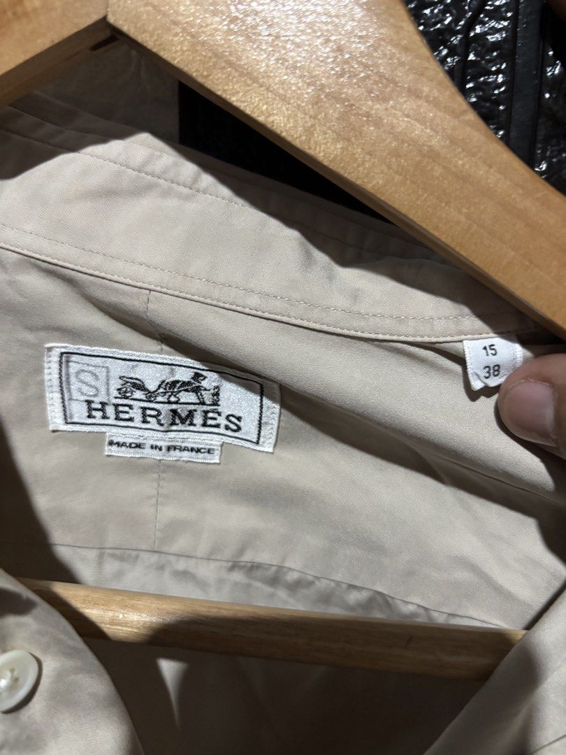 Hermes Beige Long Sleeve Shirt (Category: Luxury Apparel) located in Lopez. Submitted by thrift.ni.roms22 (Listing ID 1439818060, Image 2). Description: - Authentic Hermes long sleeve shirt - Color: Beige - Made in France - Size: 15/38 - Material: 100% cotton - Features a classic collar and button-down closure - A timeless wardrobe staple.