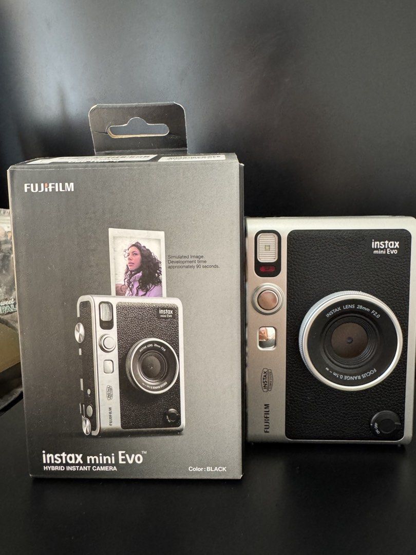 Instax Mini Evo (Category: Cameras) located in Manila. Submitted by preloveditemsxz (Listing ID 1439859639, Image 1). Description: Fujifilm Instax Mini Evo instant camera (black) - Produces instant prints - Bluetooth phone printer function - Can save photos digitally before printing -Rechargeable battery Inclusions: ✅Box ✅Manuals ✅Orig Strap ✅Receipt bought last Oct 2025 ✅Type C Charger ✅2 remaining films ✅32gb microSD RFS: Rarely used / declutte