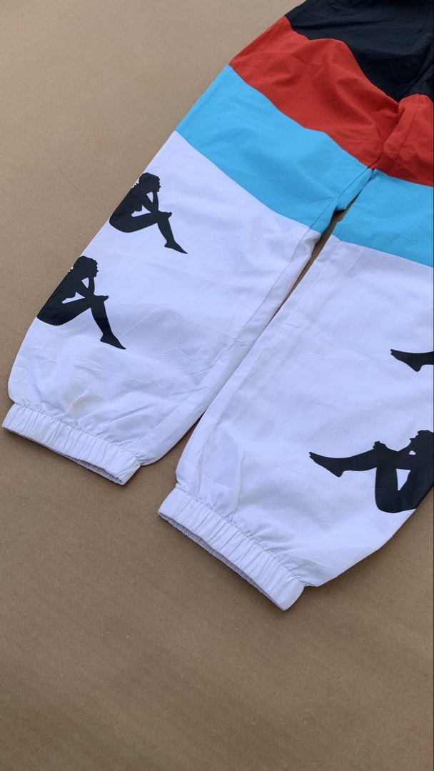 Kappa Track Pants (Category: Joggers) located in Jamindan. Submitted by darinville30528 (Listing ID 1439951042, Image 3). Description: - Waistline: 28-32 - Length: 39 - Condition: 10/10 - Color Rate: 10/10 - No Issue💯 - Stylish Kappa track pants - Bold colorblock design: black, red, and white - White lower leg with multiple Kappa logo prints - Comfortable elastic waistband with drawstring - Convenient zippered back pocket - Ideal for casual wear