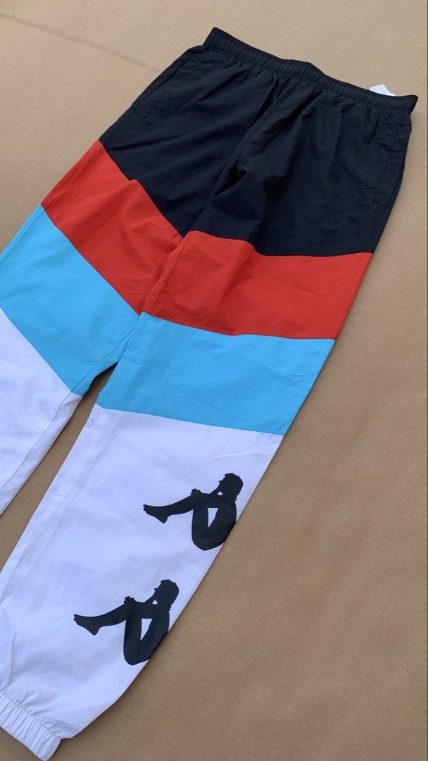 Kappa Track Pants (Category: Joggers) located in Jamindan. Submitted by darinville30528 (Listing ID 1439951042, Image 2). Description: - Waistline: 28-32 - Length: 39 - Condition: 10/10 - Color Rate: 10/10 - No Issue💯 - Stylish Kappa track pants - Bold colorblock design: black, red, and white - White lower leg with multiple Kappa logo prints - Comfortable elastic waistband with drawstring - Convenient zippered back pocket - Ideal for casual wear