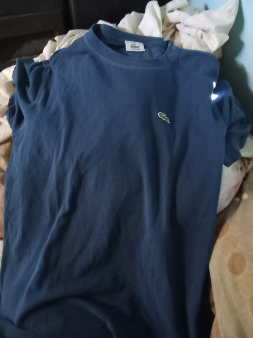 Lacoste Navy Blue T-shirt with Crocodile Logo (Category: Tshirts & Polo Shirts ) located in Dinalupihan. Submitted by yanyan.thirft (Listing ID 1439971779, Image 3). Description: - Classic navy blue t-shirt - Features iconic embroidered green crocodile logo on chest - Comfortable and versatile for everyday wear - Perfect for casual outfits.