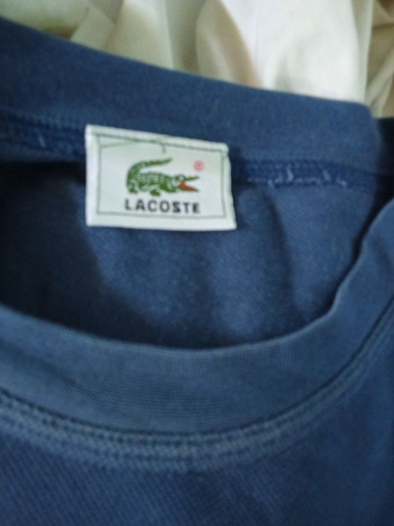 Lacoste Navy Blue T-shirt with Crocodile Logo (Category: Tshirts & Polo Shirts ) located in Dinalupihan. Submitted by yanyan.thirft (Listing ID 1439971779, Image 2). Description: - Classic navy blue t-shirt - Features iconic embroidered green crocodile logo on chest - Comfortable and versatile for everyday wear - Perfect for casual outfits.