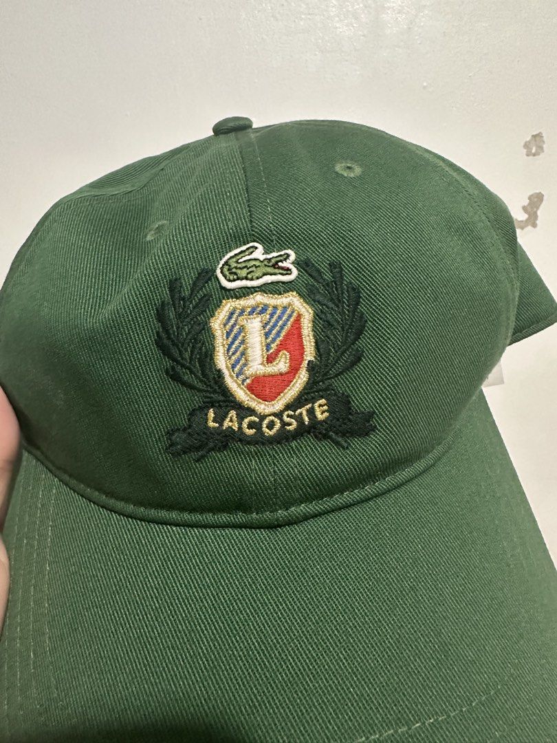 Lacoste Unisex Embroidered Twill Cap (Category: Caps & Hats) located in Cainta. Submitted by xyzasisa (Listing ID 1439955996, Image 2). Description: - Authentic Green Lacoste Cap - Prominent embroidered crest logo with 'L' and Lacoste crocodile - Adjustable strap at the back with embossed metal buckle - Interior lining and sweatband printed with Lacoste branding.