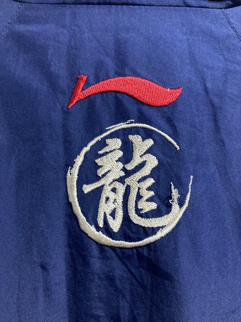 Li-Ning Navy Blue Track Jacket 3XL (Category: Coats, Jackets and Outerwear) located in Iloilo. Submitted by __kyleeee__ (Listing ID 1439916133, Image 3). Description: - Li-Ning track jacket for active and stylish wear. - Full zip closure and stand-up collar. - Eye-catching blue and Greek-key inspired accents on sleeves and sides. - Prominent embroidered dragon motif on the back. - Ideal for workouts or casual outings..