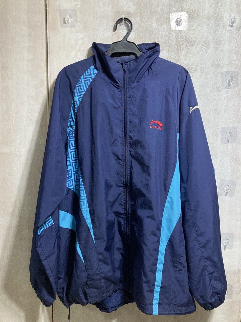 Li-Ning Navy Blue Track Jacket 3XL (Category: Coats, Jackets and Outerwear) located in Iloilo. Submitted by __kyleeee__ (Listing ID 1439916133, Image 1). Description: - Li-Ning track jacket for active and stylish wear. - Full zip closure and stand-up collar. - Eye-catching blue and Greek-key inspired accents on sleeves and sides. - Prominent embroidered dragon motif on the back. - Ideal for workouts or casual outings..