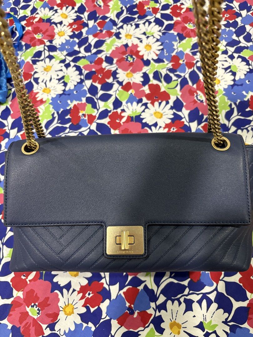 Louis Quatorze Navy Blue Shoulder Bag (Category: Shoulder Bags) located in Muntinlupa City. Submitted by rmsalberto (Listing ID 1439848140, Image 2). Description: Navy blue shoulder bag from Louis Quatorze. Features a gold-tone chain strap and a flap closure with a gold-tone clasp. The bag has a quilted design on the front and a slip pocket on the back. The interior has a zippered pocket. The brand name is visible on the clasp and the back of the