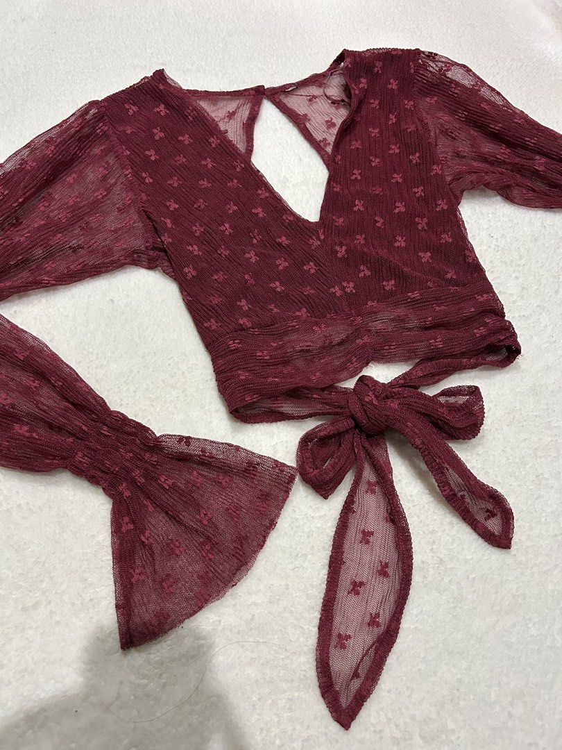 Maroon Sheer Puff Sleeve Crop Top with Tie Back (Category: Blouses) located in Bambang. Submitted by weeeyyaaa (Listing ID 1439931459, Image 2). Description: - Chic maroon crop top - Sheer, textured fabric with subtle all-over pattern - Flattering V-neckline - Voluminous puff sleeves with flared cuffs - Adjustable tie-back closure - Perfect for evening wear or special occasions -can fit s-semi m.