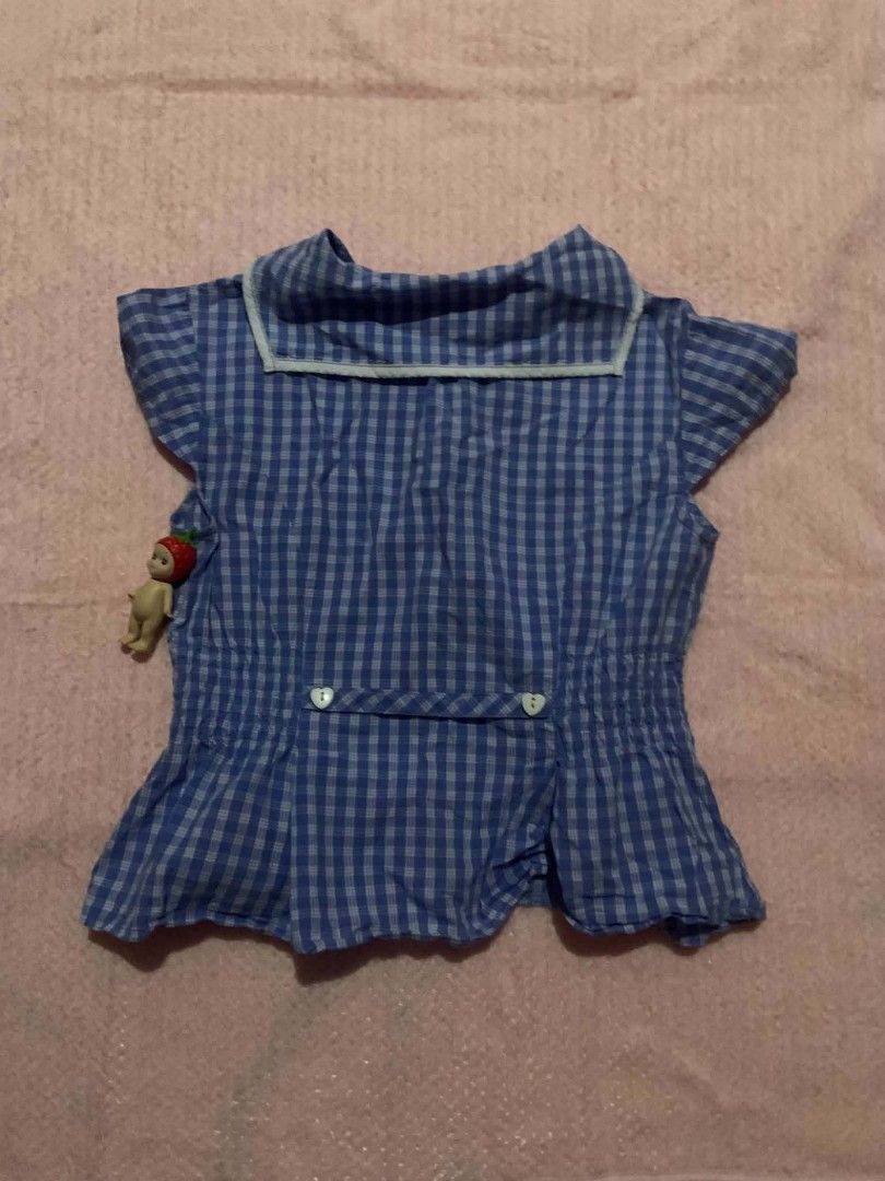 Mary y Cielo Blue Gingham Peplum Top (Category: Sleeveless) located in San Nicolas. Submitted by bissouluv (Listing ID 1439946381, Image 3). Description: - Charming blue gingham peplum top - Features a white Peter Pan collar - Button-down front - Short flutter sleeves - Flattering flared hemline - Perfect for a cute and playful look.