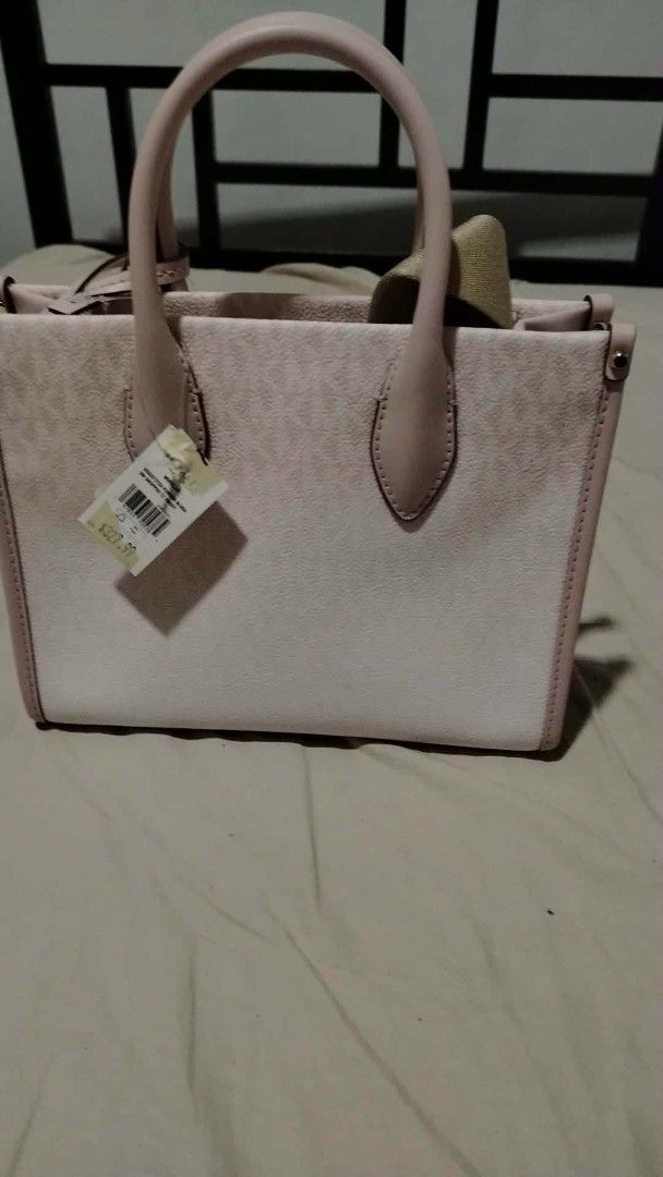Michael Kors Pink Logo Tote Bag (Category: Luxury Bags & Wallets) located in Caloocan City. Submitted by teyegugu (Listing ID 1439972253, Image 2). Description: - Authentic Michael Kors tote bag - Lovely pink color - Signature MK logo pattern all over - Top handles for easy carrying - Structured design for a polished look - Perfect for everyday use or any occasion 💯 original and authentic binili ko kay Jace Minishop .