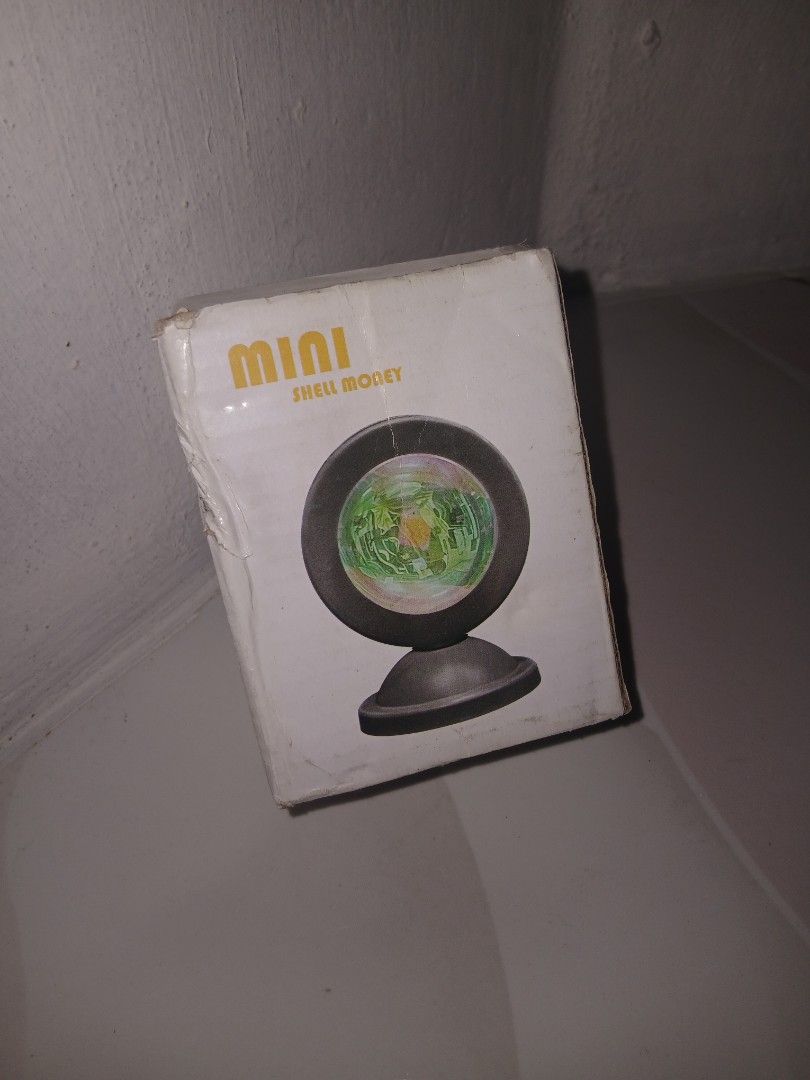 Mini Sunset Lamp Projector (Category: Lighting) located in Quezon City. Submitted by dhanezahclarizzz (Listing ID 1439941598, Image 1). Description: - Mini projector lamp for a beautiful sunset ambiance. - Multiple lighting modes: sunset red, iridescent purple, rainbow, and RGB. - Compact design fits perfectly in any room. - Simple plug-and-play operation for instant colorful glow..