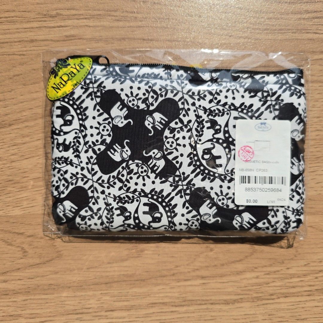 Naraya Elephant Print Pouch (Category: Purses & Pouches) located in Quezon City. Submitted by declutterwithnic (Listing ID 1439864925, Image 1). Description: Naraya pouch with unique elephant print - Brand new, still in original packaging - Features a stylish black zipper - Eye-catching black and white pattern - Small, rectangular design - Ideal for carrying small essentials - Brand tag visible.