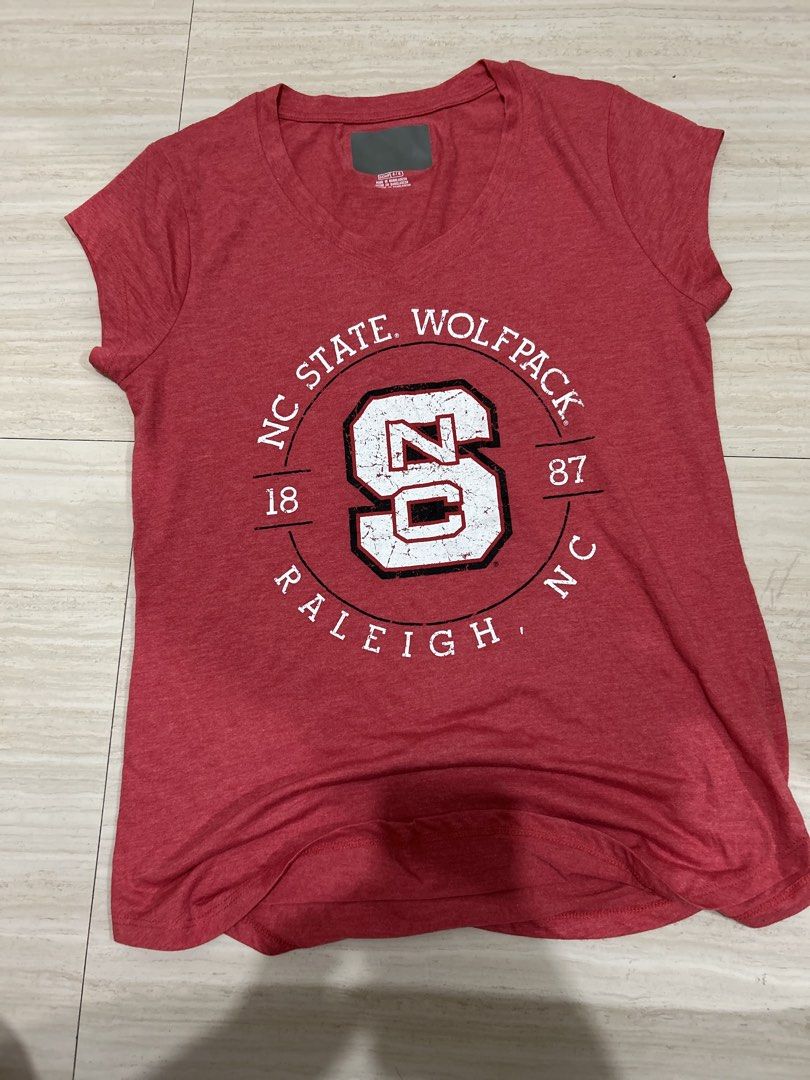 NC State Wolfpack Raleigh Red T-shirt (Category: Shirts) located in Pasig City. Submitted by krishnasingh2020 (Listing ID 1439927440, Image 1). Description: - Classic red t-shirt supporting the NC State Wolfpack. - Features iconic 'NC State Wolfpack Raleigh' graphic. - Includes the year '1887' and the prominent 'S' logo. - Made from comfortable fabric for everyday wear. - Perfect for game days and showing your team spirit..