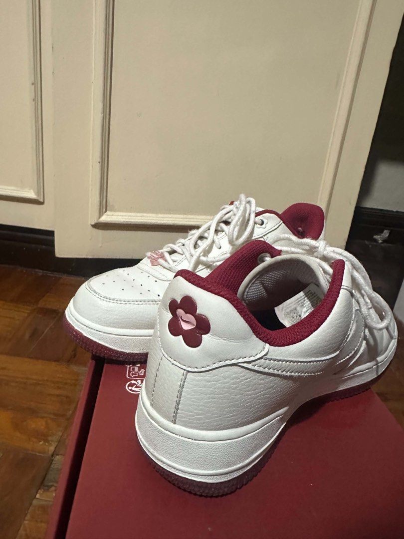 Nike Air Force 1 Low Cherry Blossom White Red (Category: Sneakers) located in Manila. Submitted by angeloujos65502 (Listing ID 1439954603, Image 3). Description: - Authentic Nike Air Force 1 Low sneakers - Color: White with Red accents - Unique cherry blossom detail on the heel - Glittery red outsole - Size: 5 UK / 38.5 EUR - Perfect for adding style to any outfit.