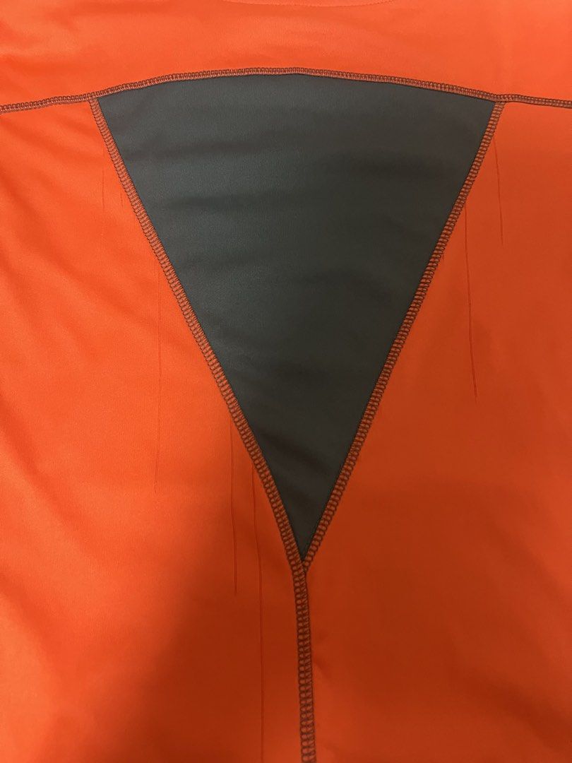 Nike Orange Long Sleeve Athletic Shirt (Category: Tshirts & Polo Shirts ) located in Manila. Submitted by oddcat.ac8a4a (Listing ID 1439947694, Image 3). Description: Vibrant orange Nike long-sleeved athletic shirt with black swoosh. Features dark grey side panels and a V-shaped back panel for breathability. Dark grey stitching..