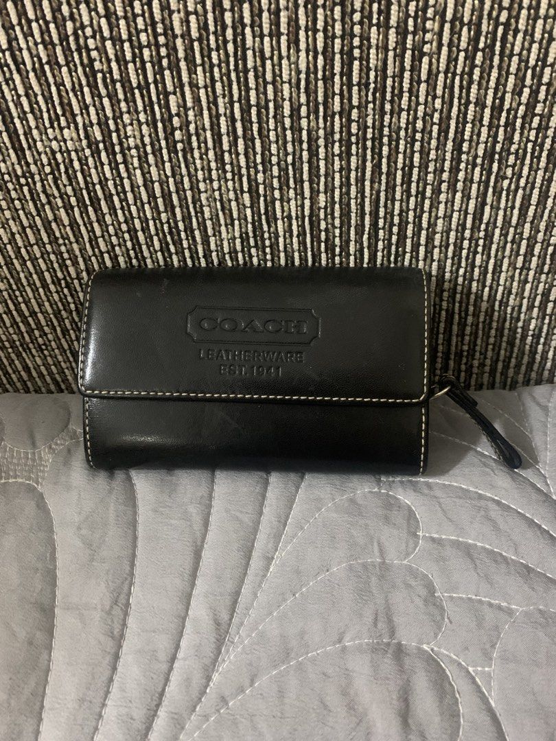 Original Coach Cowhide Leather Bifold Wallet (SALE) (Category: Luxury Bags & Wallets) located in Quezon City. Submitted by shopersville (Listing ID 1439901860, Image 1). Description: - Original Coach wallet in black cowhide leather. Rare piece. - Embossede Coach Leatherware Est. 1941 logo on front flap - Secure snap closure - Zippered compartment for coins/essentials - Stylish and practical for everyday use - Preloved with some signs of use.