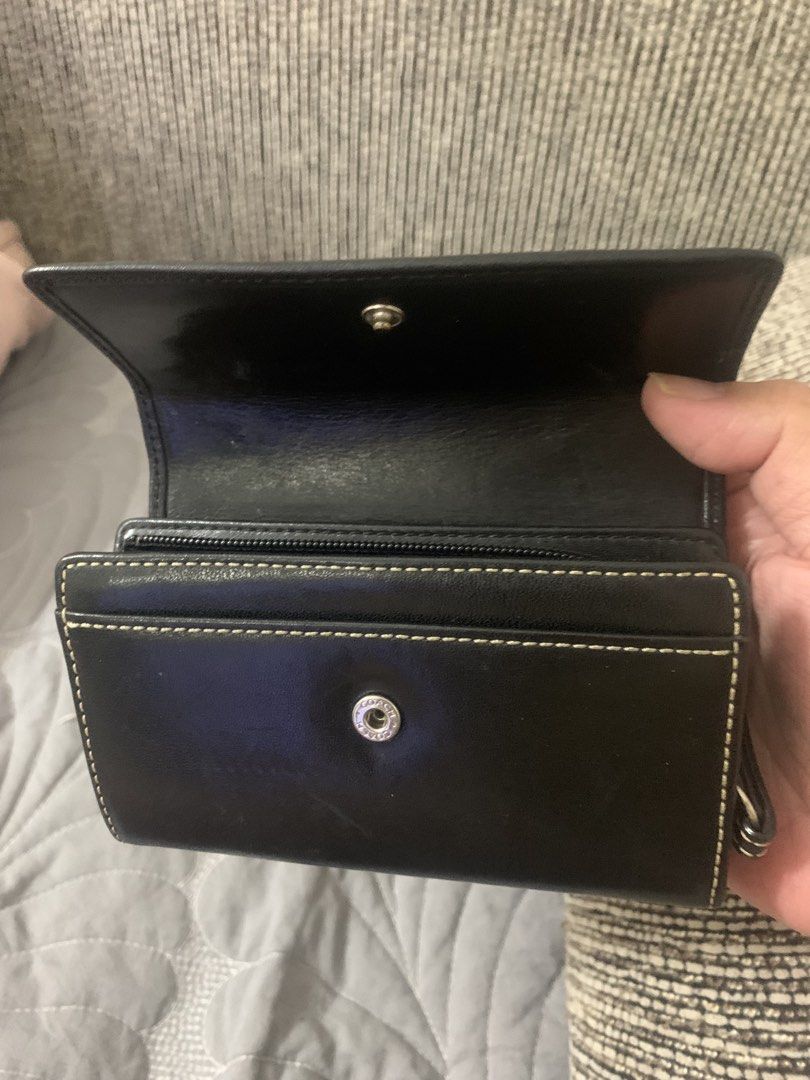 Original Coach Cowhide Leather Bifold Wallet (SALE) (Category: Luxury Bags & Wallets) located in Quezon City. Submitted by shopersville (Listing ID 1439901860, Image 3). Description: - Original Coach wallet in black cowhide leather. Rare piece. - Embossede Coach Leatherware Est. 1941 logo on front flap - Secure snap closure - Zippered compartment for coins/essentials - Stylish and practical for everyday use - Preloved with some signs of use.