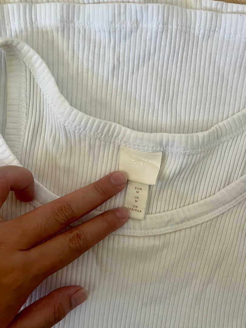 Original H&M Ribbed Tank Top - Size M (Category: Sleeveless) located in Cavite. Submitted by myzn_ (Listing ID 1439869879, Image 2). Description: - H&M white ribbed tank top - Size: M - Material: Cotton and elastane blend - Color: White - Condition: Good, used once.