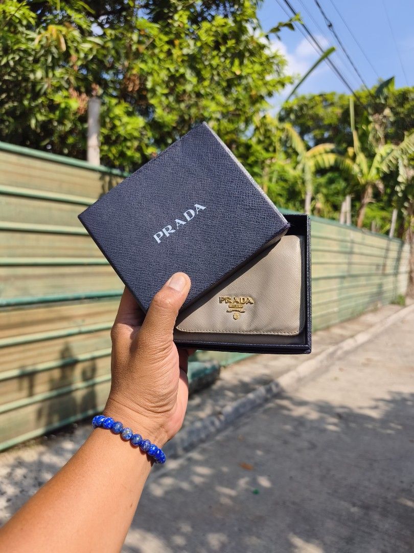 Prada Saffiano Trifold Wallet (Category: Luxury Bags & Wallets) located in Bulacan. Submitted by THA_D_THRIFT (Listing ID 1439924449, Image 1). Description: - Authentic Prada Saffiano Trifold Wallet - Classic and iconic design - Made with premium Saffiano leather - Features the signature Prada logo - Multiple card slots and compartments for organization - Comes with original Prada box FRESH FROM JAPAN SOURCE EXCELLENT DONDITION SIGN OF USAGE CLEA