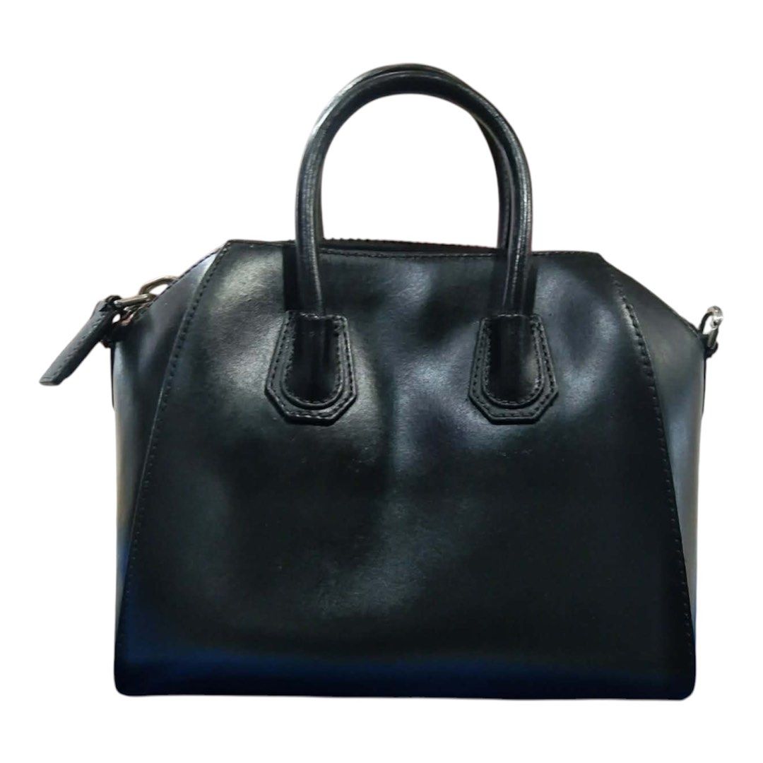 Preloved Givenchy Antigona Small Black Leather Handbag (Category: Luxury Bags & Wallets) located in Las Pinas. Submitted by danechanel (Listing ID 1439860422, Image 2). Description: - Authentic Givenchy Antigona handbag - Color: Black - Features: Structured silhouette, top handles, detachable shoulder strap - Closure: Zip closure - Details: Givenchy logo on front - Material: Leather - Design: Classic and versatile - with strap and dust bag - Mana