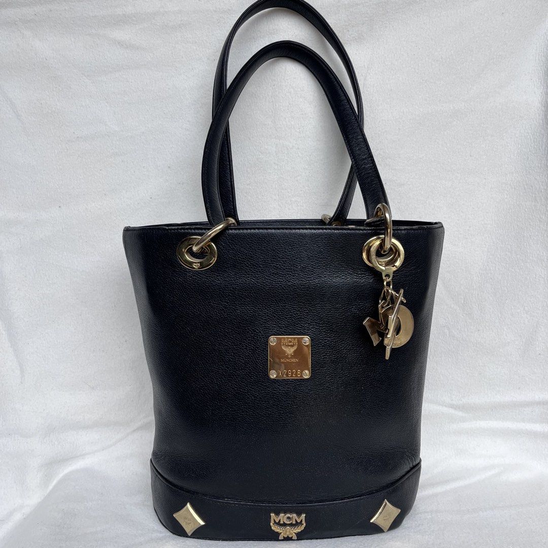 Preloved MCM Black Bucket Tote (Category: Luxury Bags & Wallets) located in Zamboanga. Submitted by shop.radandfab (Listing ID 1439955505, Image 1). Description: Preloved MCM Black Bucket Tote With signs of usage( minimal scuffs and peelings) but still in good conndition .