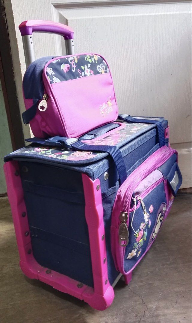 Robby Rabbit Rolling Backpack with Lunch Bag (Category: Backpacks) located in Marikina City. Submitted by pre_lovedbydaphne (Listing ID 1439937683, Image 3). Description: - Cute Robby Rabbit rolling backpack set, perfect for school. - Spacious main compartment with internal organizers. - Front zippered pocket for quick access. - Includes a matching lunch bag. - Durable wheels and retractable handle for easy transport. - Vibrant pink and blue desi