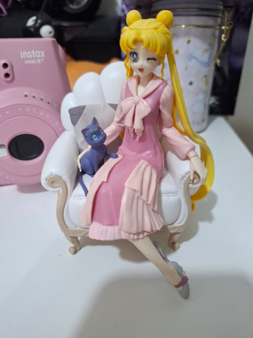 Sailor Moon Figure (Category: Figurines & Statues) located in Orion. Submitted by timburtonfan (Listing ID 1439924365, Image 1). Description: - Sailor Moon collectible figure - Features character in a pink dress - Posed elegantly lounging on a chair - Includes a blue cat companion - Blonde hair detail - Ideal for Sailor Moon enthusiasts.