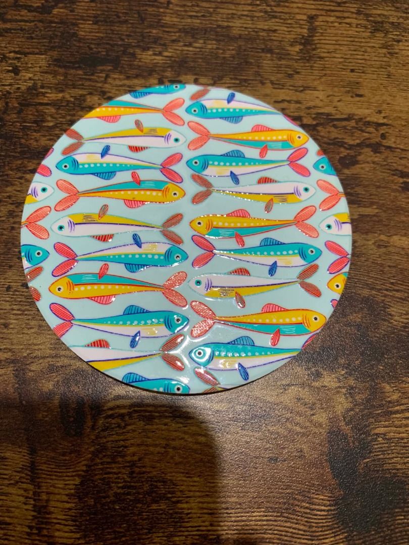 Solo Round Ceramic Coaster with Colorful Fish Design (Category: Other Kitchenware & Tableware) located in Bacolod City. Submitted by kyaramatcha (Listing ID 1439919158, Image 3). Description: - Round coaster with vibrant fish pattern - Colors: Blue, yellow, red, orange fish on light blue background - Protects surfaces from drinks - Adds a touch of whimsy to your home decor .