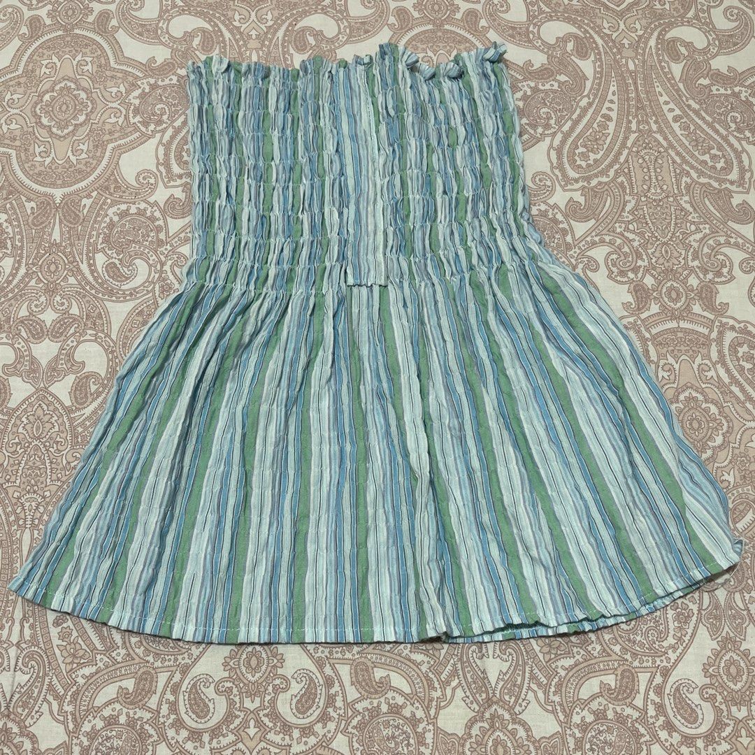 Striped Smocked Tube Top (Category: Sleeveless) located in Belison. Submitted by prelovedbyellery (Listing ID 1439958525, Image 1). Description: - Cute and comfortable smocked tube top - Features a vertical blue and green stripe pattern - Stretchy smocked bodice for a snug fit - Flowy, flared hemline - Perfect for a casual and stylish look.