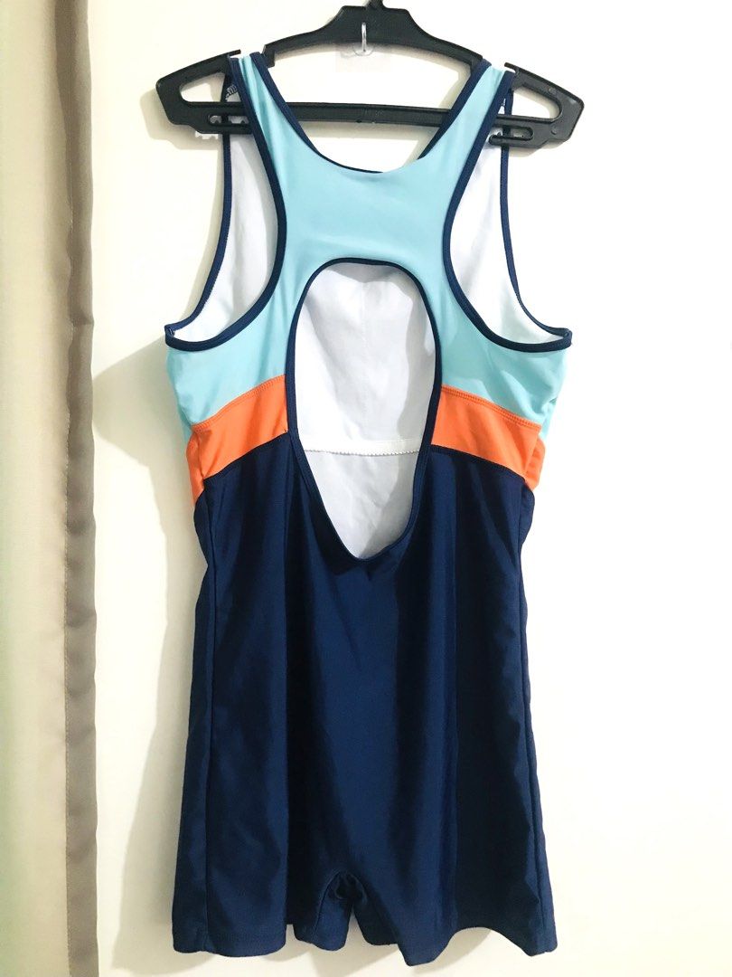 Surf Club Swimsuit (Category: Bikinis & Swimsuits) located in Quezon City. Submitted by mae_iggy (Listing ID 1439848369, Image 3). Description: - Navy blue one-piece swimsuit - Accented with light blue and orange - Features a Surf Club logo - Racerback design with open back - Sleeveless - Round neckline - Short bottoms.