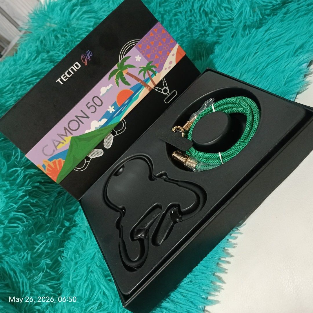 TECNO CAMON 50 Gift Box with Earphones (Category: Earphones) located in Quezon City. Submitted by mackyisa17. (Listing ID 1439990212, Image 3). Description: - Unbox a stylish TECNO CAMON 50 gift set. - Includes sleek black in-ear earphones. - Features a vibrant green braided cable. - Comes with a convenient carrying case. - Perfect for music lovers on the go..