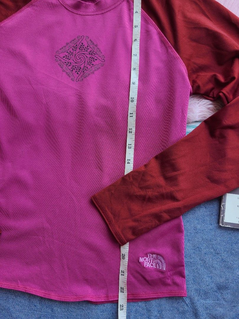 The North Face Long rush guard (Category: Tshirts & Polo Shirts ) located in Lingayen. Submitted by chloeswhite (Listing ID 1439833319, Image 3). Description: - The North Face long-sleeved shirt - Vibrant pink body with maroon sleeves - Classic crew neck - Features a unique design on the front - The North Face logo on front and back - Made of a lightweight, possibly athletic material - Measurements available in the images -small-medium.
