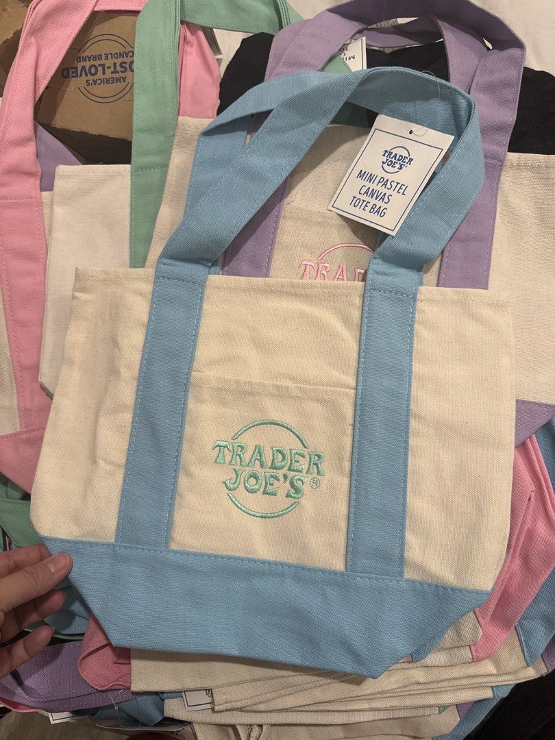 Trader Joe's Mini Pastel Canvas Tote Bag (Category: Tote Bags) located in Cavite. Submitted by your.unique.treasure (Listing ID 1439929114, Image 3). Description: - 100% ORIGINAL from US - Trader Joe's mini tote bags - Available in pastel blue, purple, pink, and mint green - Features iconic embroidered Trader Joe's logo - Includes a convenient front pocket - Perfect for everyday use, shopping, or as a stylish accessory.