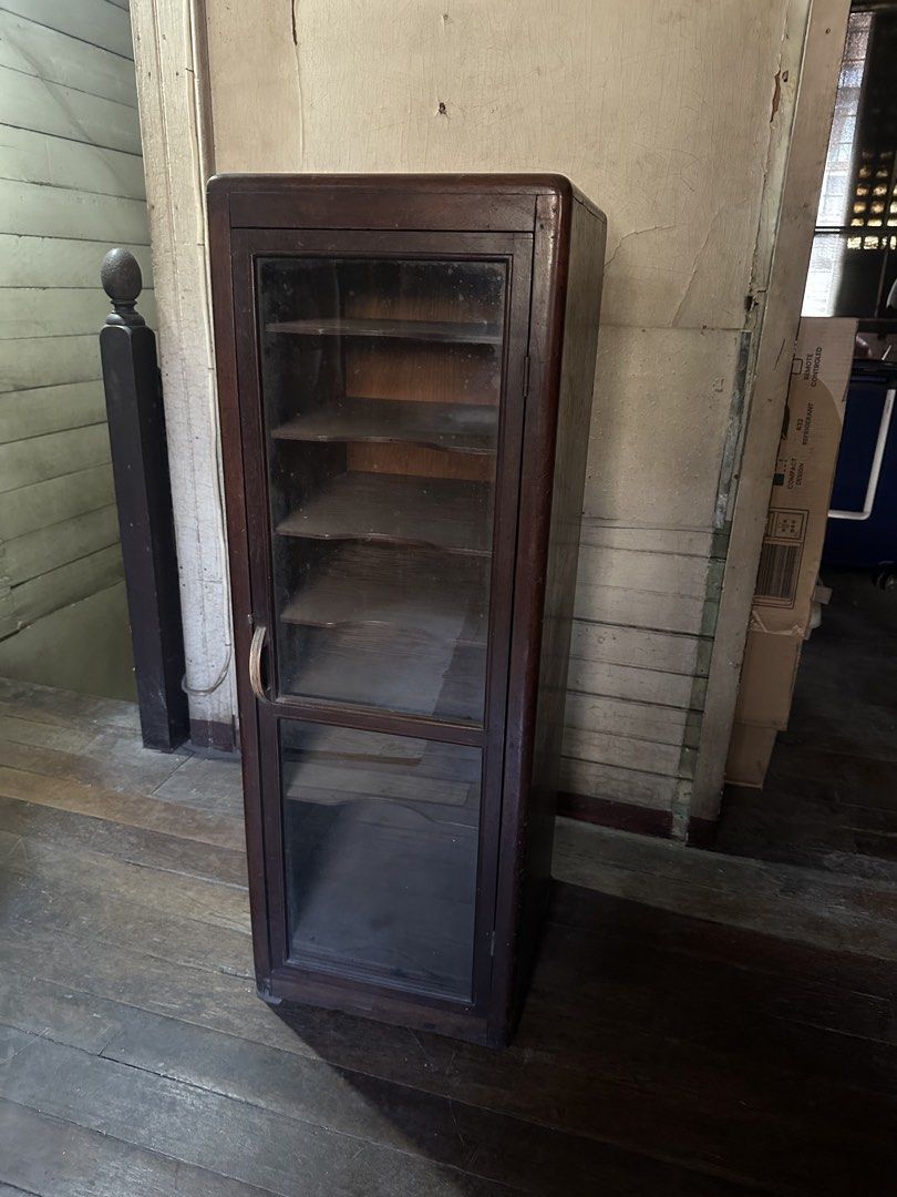 Vintage Wooden Display Cabinet with Glass Door (Category: Shelves, Cabinets & Racks) located in Manila. Submitted by clamchowder19 (Listing ID 1439942855, Image 1). Description: - Vintage wooden display cabinet - Features a glass door - Multiple shelves for display or storage - Classic dark wood finish - Compact design, suitable for any room - Ideal for showcasing collectibles.